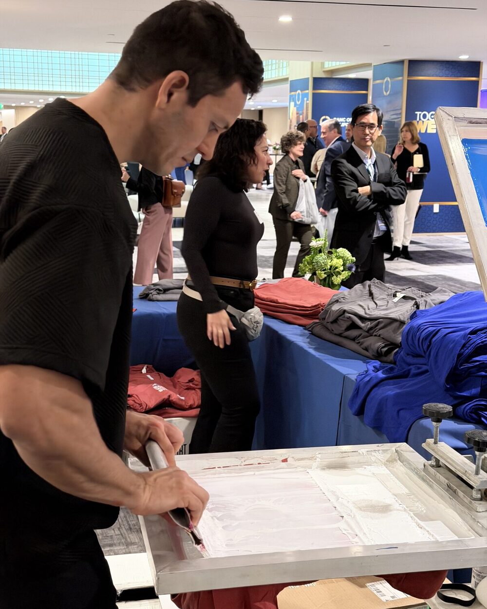 An operator pulling a print at a live event printing booth